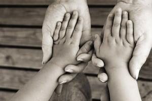 Person and kid holding hands