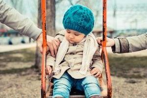 Kid sitting in a swing