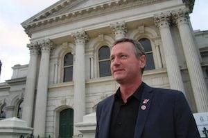 Man standing in front of a court building