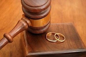 Wedding rings over a table and a chisel